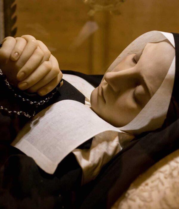 St Bernadette with rosary in repose at Lourdes pilgrimage tour