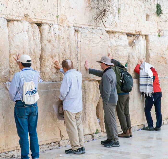 praying at western wall jerusalem pilgrimage tour holy land