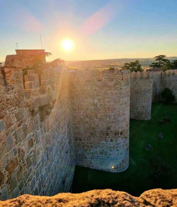 walls of avila spain at sunrise pilgrimage tour
